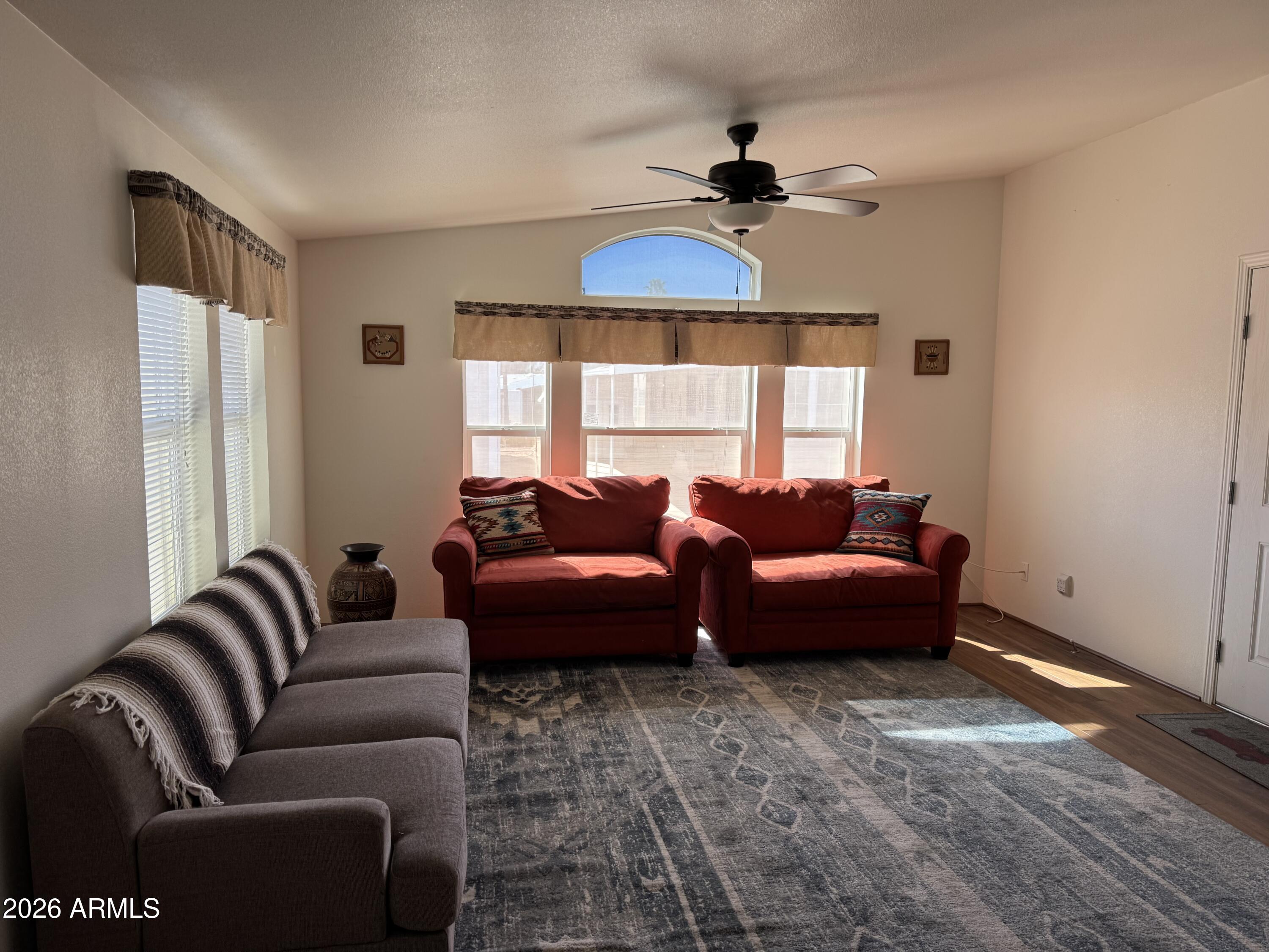 17200 West Bell Road, Unit 1658 Surprise, AZ 85374 - Photo 2 of 16 a living room with furniture and a large window