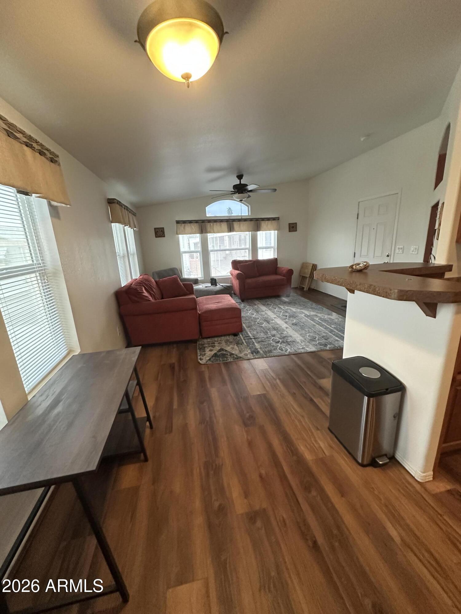 17200 West Bell Road, Unit 1658 Surprise, AZ 85374 - Photo 4 of 16 a living room with furniture and a chandelier