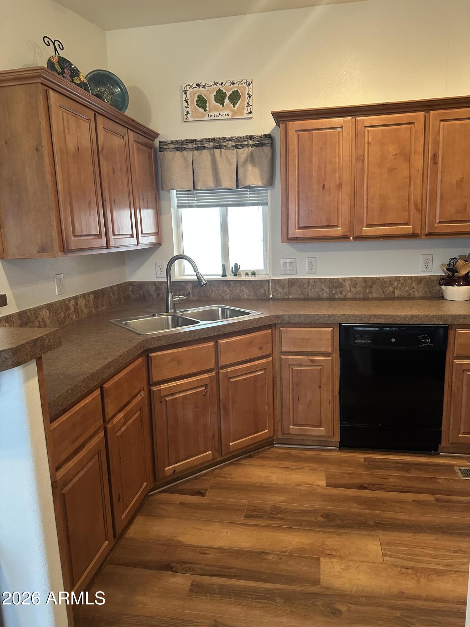 17200 West Bell Road, Unit 1658 Surprise, AZ 85374 - Photo 5 of 16 a kitchen with stainless steel appliances granite countertop a sink stove and cabinets