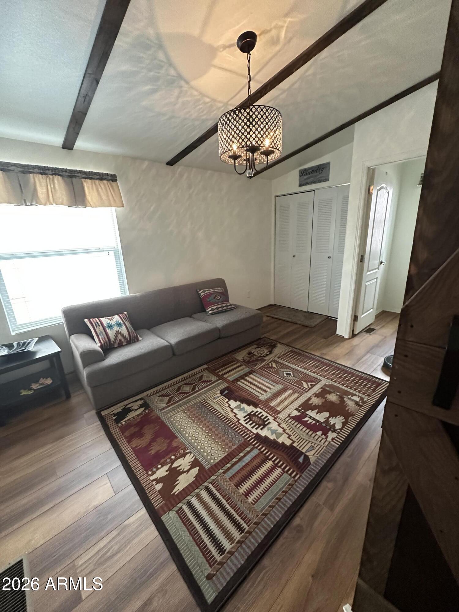 17200 West Bell Road, Unit 1658 Surprise, AZ 85374 - Photo 7 of 16 a bed sitting in a bedroom next to a window