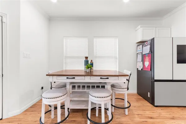 a dining room with furniture and wooden floor