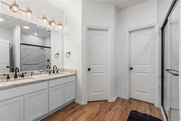 a bathroom with a double vanity sink and mirror
