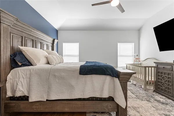 a bedroom with a bed and flat screen tv