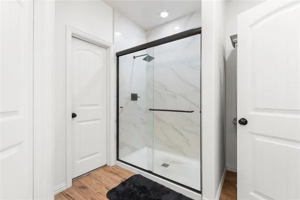 a bathroom with a glass shower door