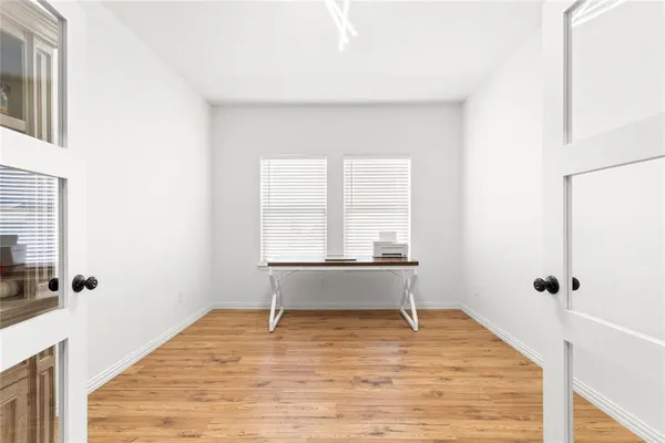 a view of a room with wooden floor and bench