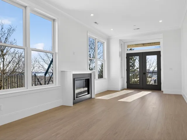 a view of an empty room with a fireplace and a window