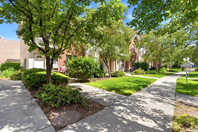 161 25th Street, Unit 6B Ogden, UT 84401 - Photo 20 of 20 Lush green landscaping with mature trees and manicured shrubs frames concrete pathways