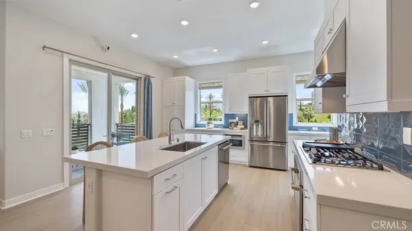 a kitchen with a sink stove and refrigerator