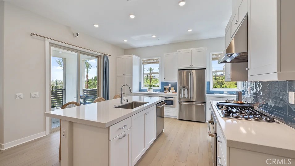 a kitchen with a sink stove and refrigerator