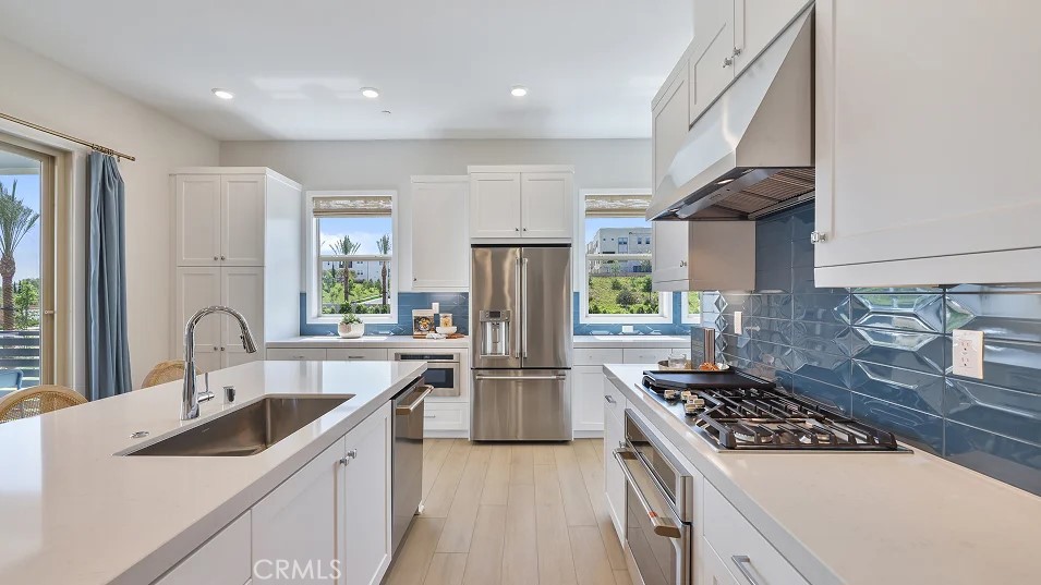 925 Walnut Terrace Montebello, CA 90640 - Photo 4 of 33 a kitchen with a stove a sink and a refrigerator