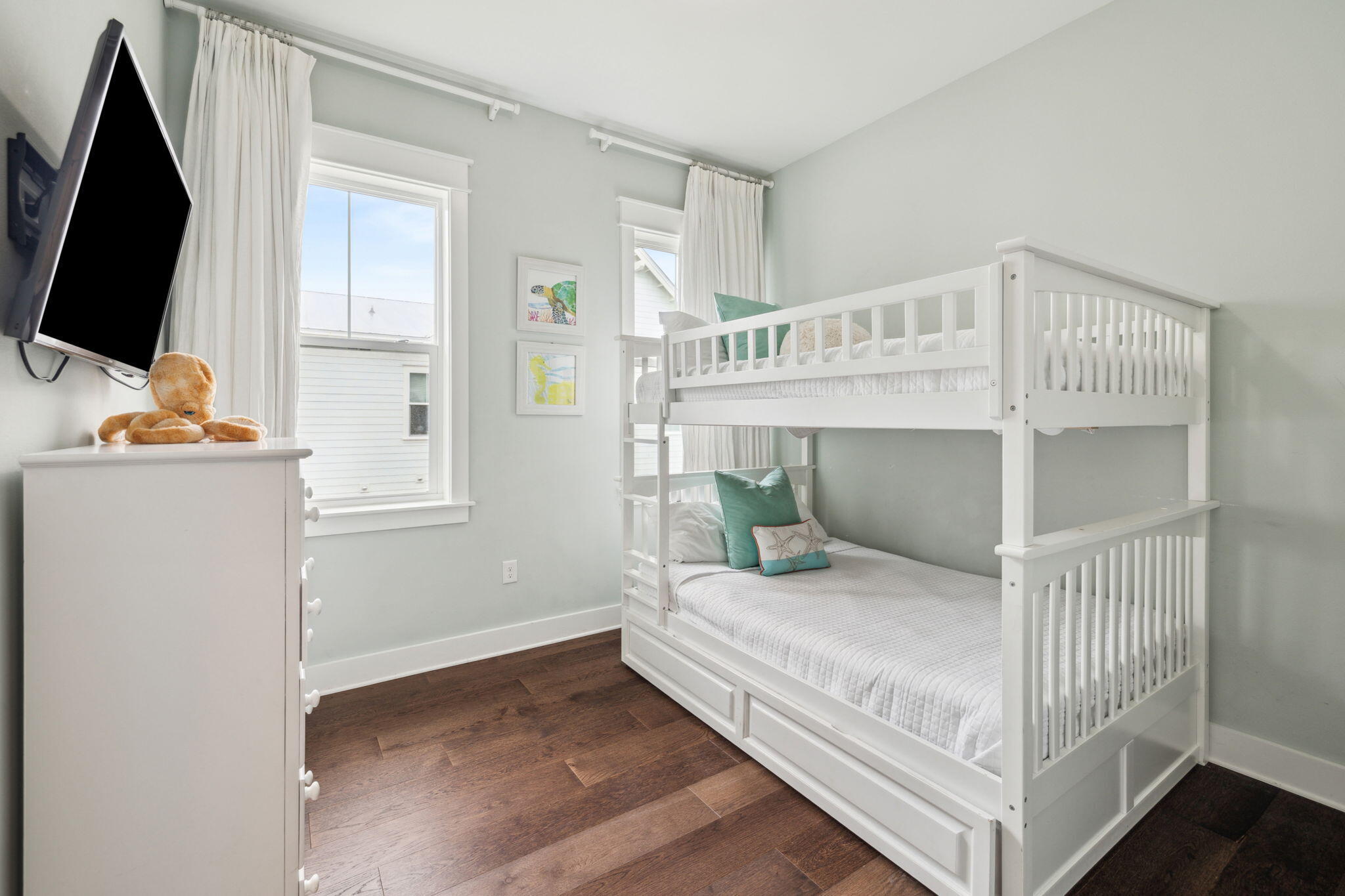 25 Pine Lands Loop East, Unit B Inlet Beach, FL 32461 - Photo 20 of 37 a bedroom with a bed and a flat tv screen on the wall