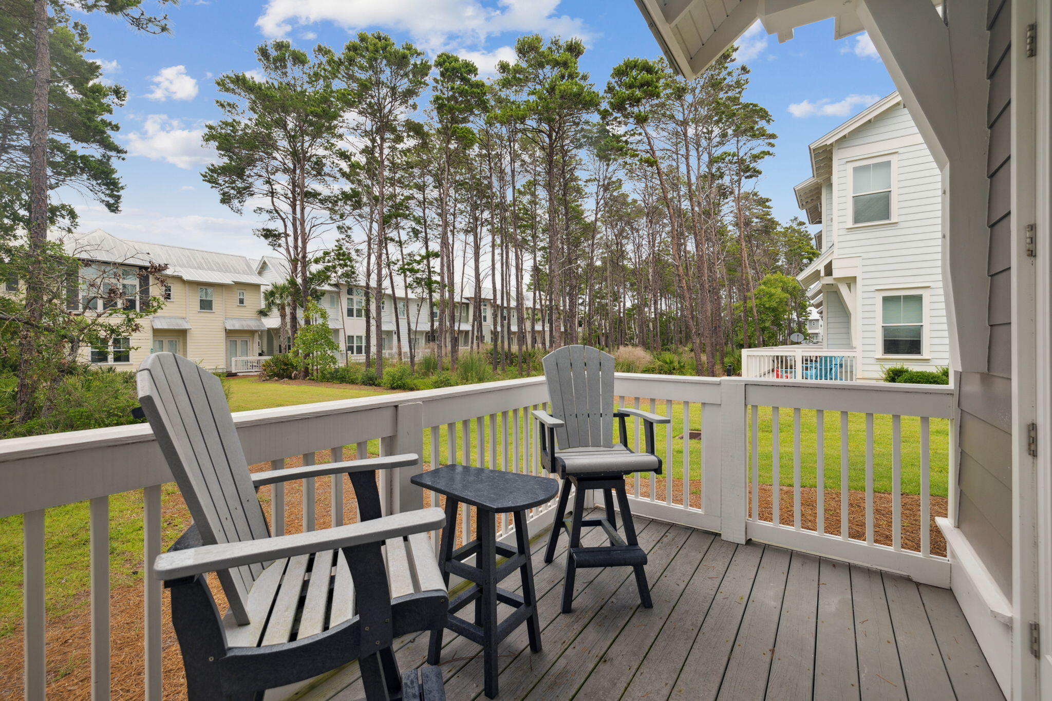 25 Pine Lands Loop East, Unit B Inlet Beach, FL 32461 - Photo 23 of 37 a view of a chair and tables in the balcony