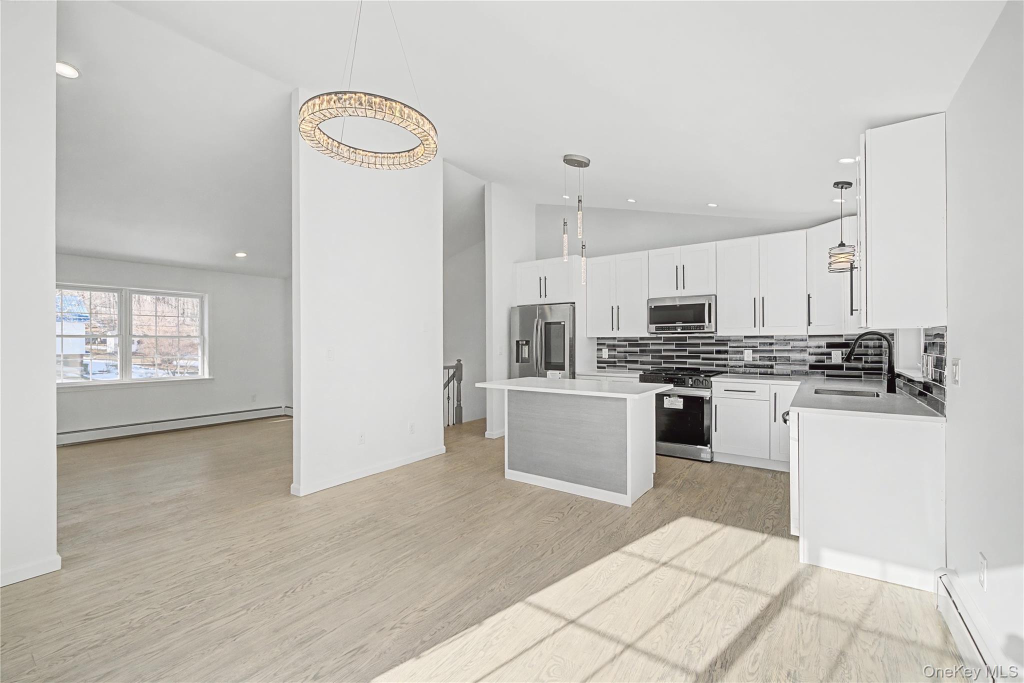 25 Clinton Street Middletown, NY 10940 - Photo 12 of 38 a kitchen with white cabinets and stainless steel appliances
