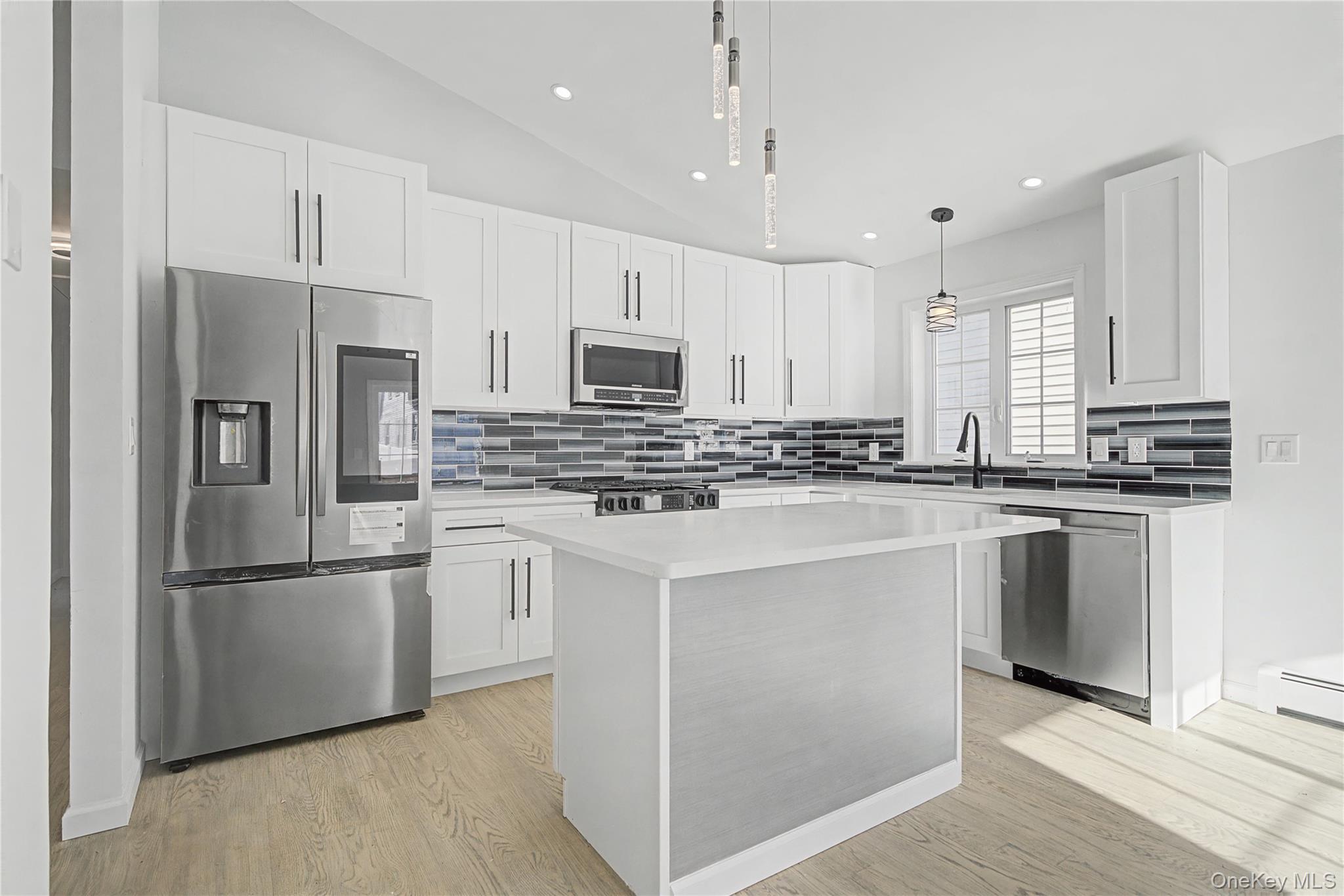 25 Clinton Street Middletown, NY 10940 - Photo 14 of 38 a kitchen with kitchen island white cabinets and stainless steel appliances