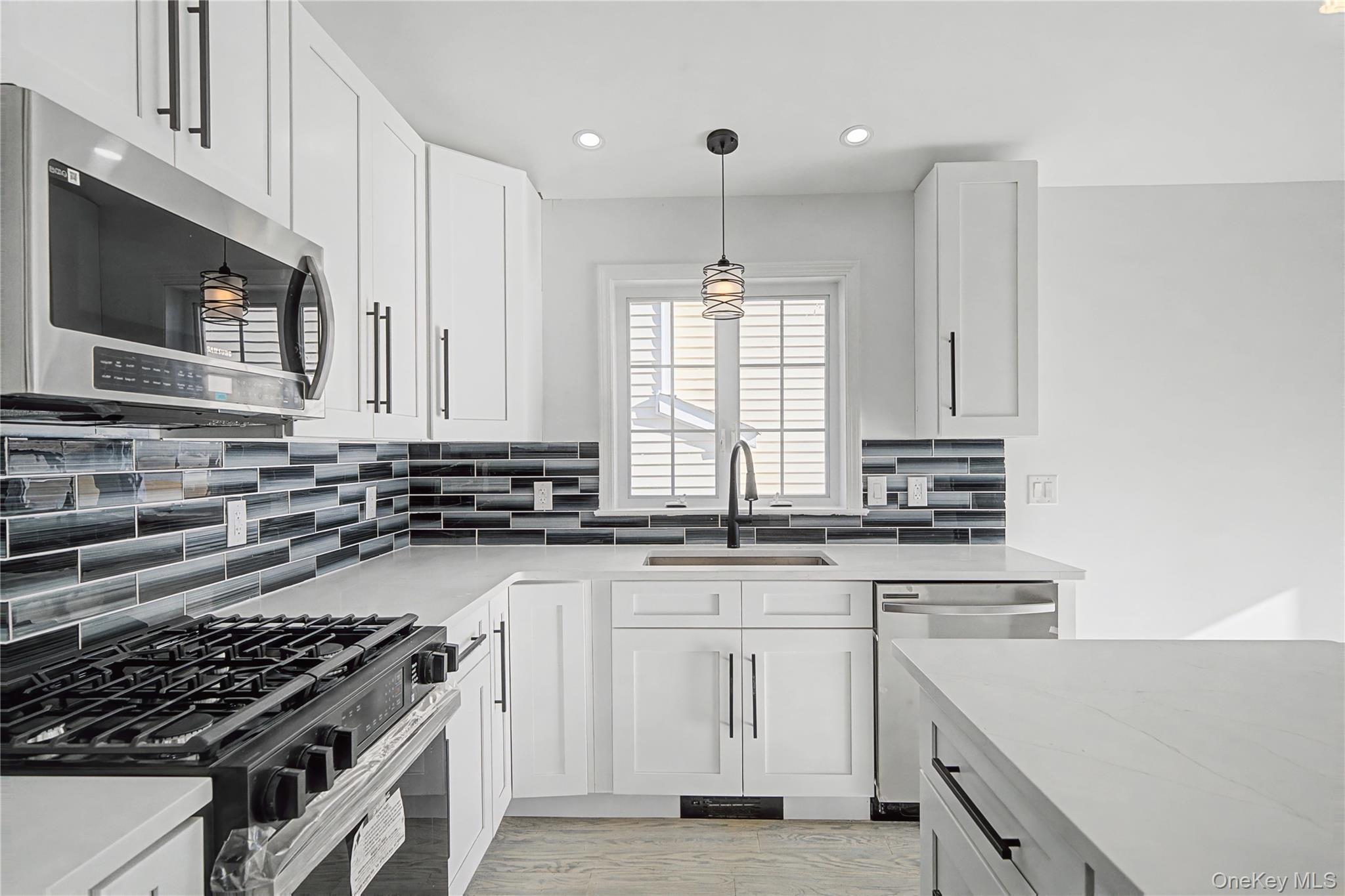25 Clinton Street Middletown, NY 10940 - Photo 17 of 38 a kitchen with cabinets appliances a sink and a counter top space