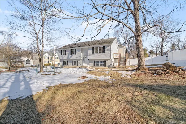 a view of staircase with railing and white walls