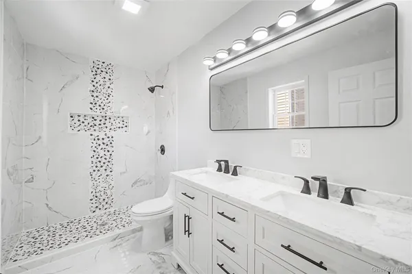 a bathroom with a sink a toilet and a mirror