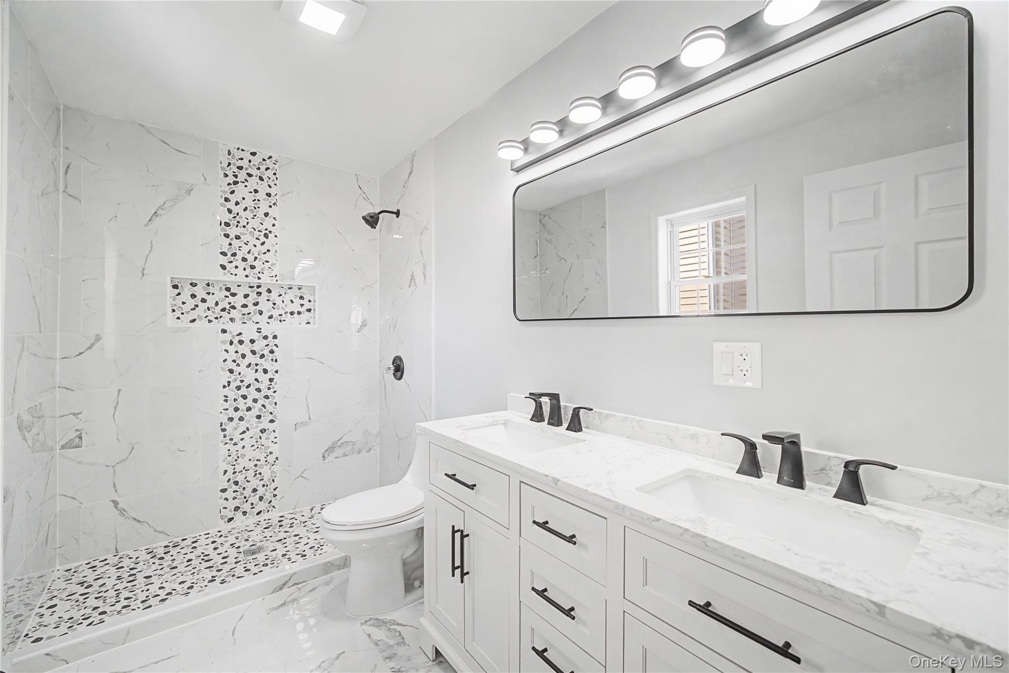 25 Clinton Street Middletown, NY 10940 - Photo 21 of 38 a bathroom with a sink a toilet and a shower