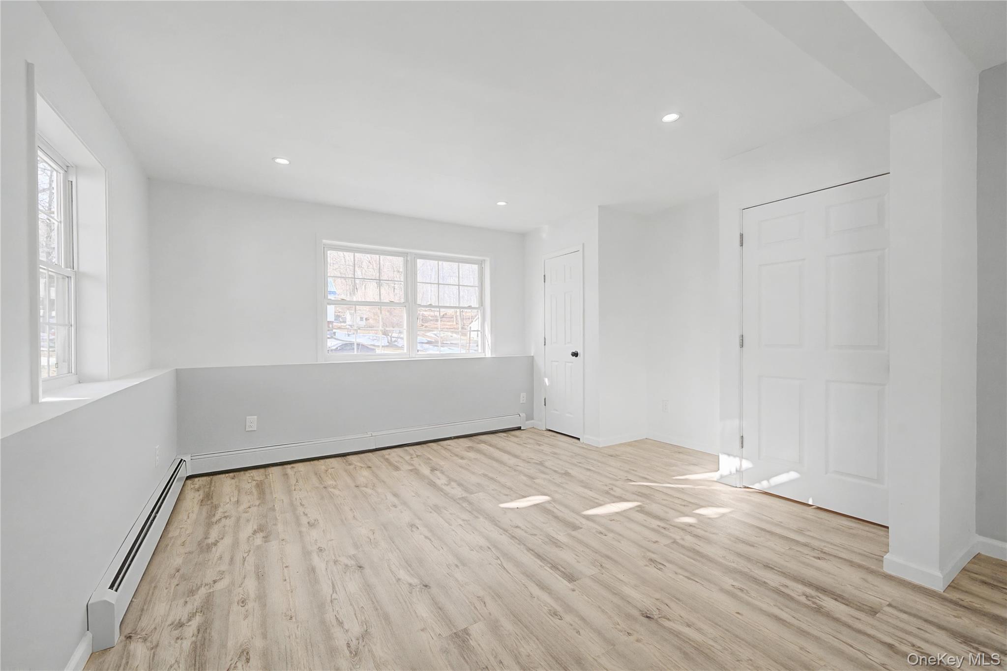 25 Clinton Street Middletown, NY 10940 - Photo 27 of 38 an empty room with wooden floor and windows