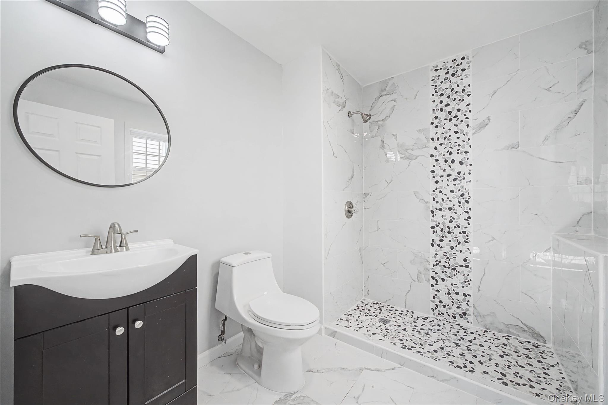 25 Clinton Street Middletown, NY 10940 - Photo 29 of 38 a bathroom with a sink a toilet and a mirror