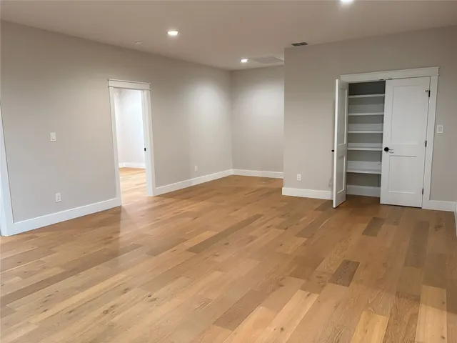 a view of an empty room with a closet