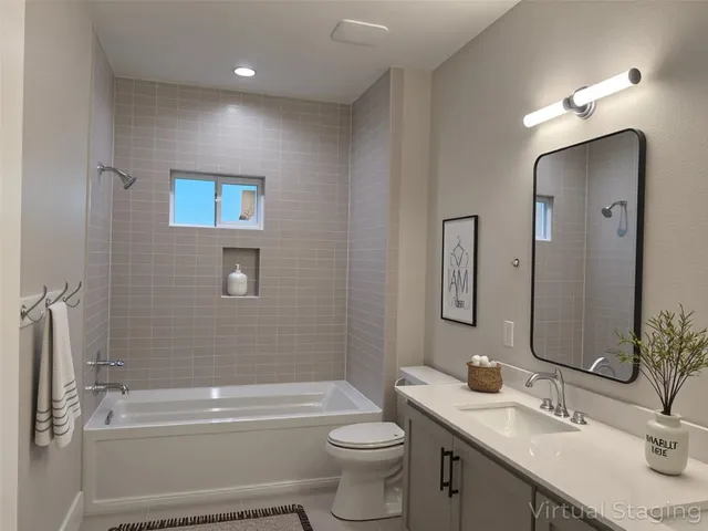 a bathroom with a toilet a sink a tub and mirror