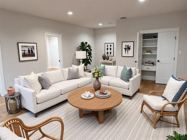 a living room with furniture and a dining table with wooden floor