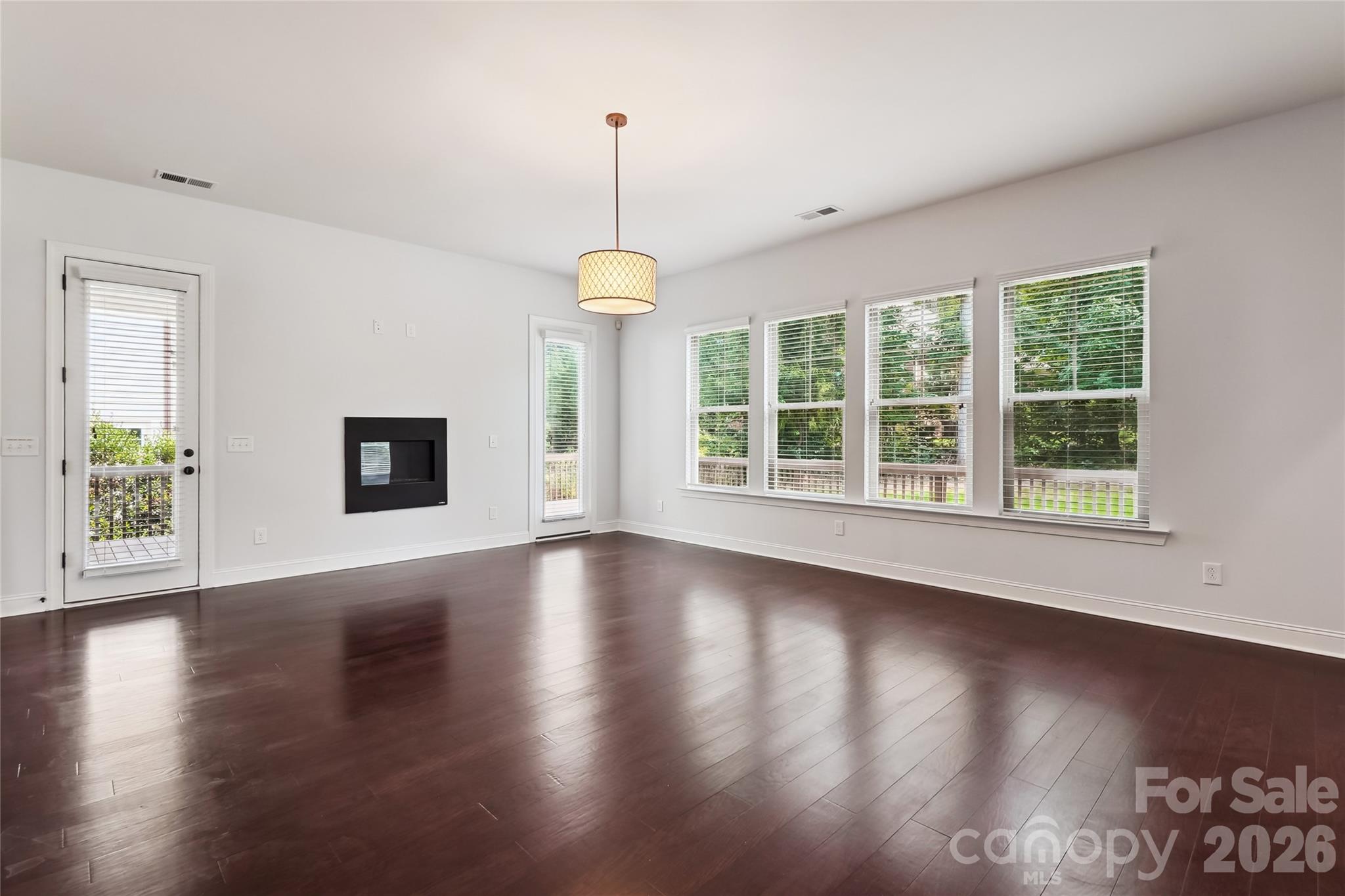 657 Chase Court Fort Mill, SC 29708 - Photo 13 of 39 a view of an empty room with wooden floor and a window