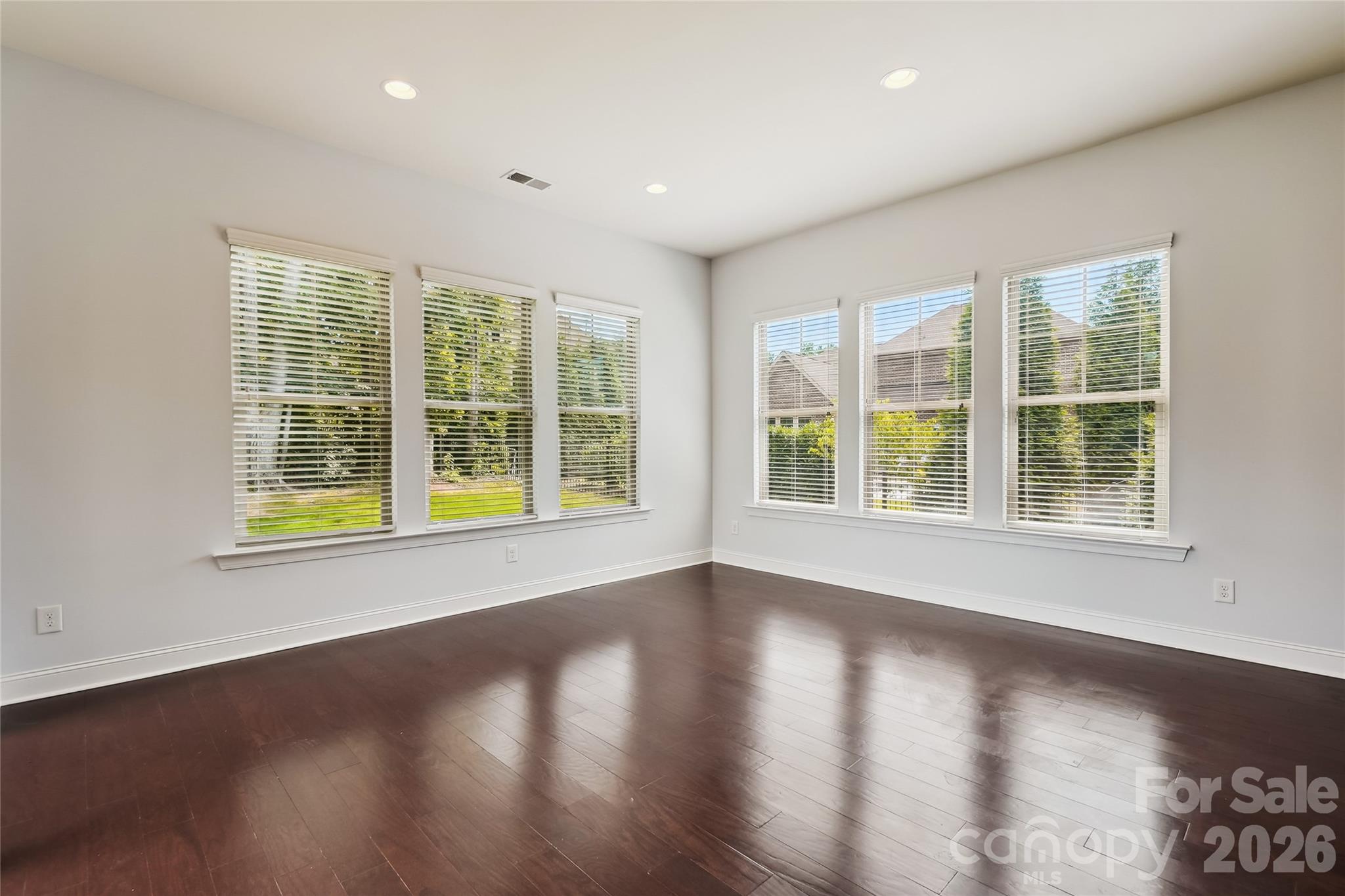 657 Chase Court Fort Mill, SC 29708 - Photo 17 of 39 a view of an empty room with wooden floor and a window