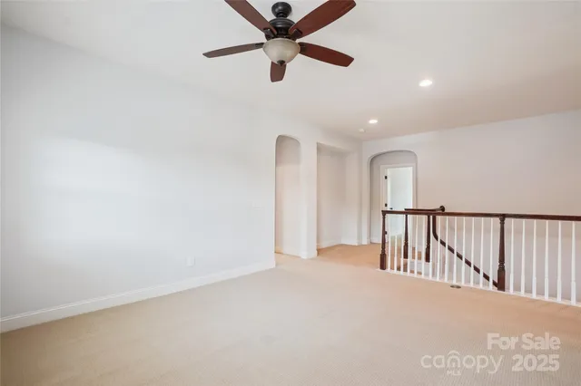 a view of a hallway with a ceiling fan