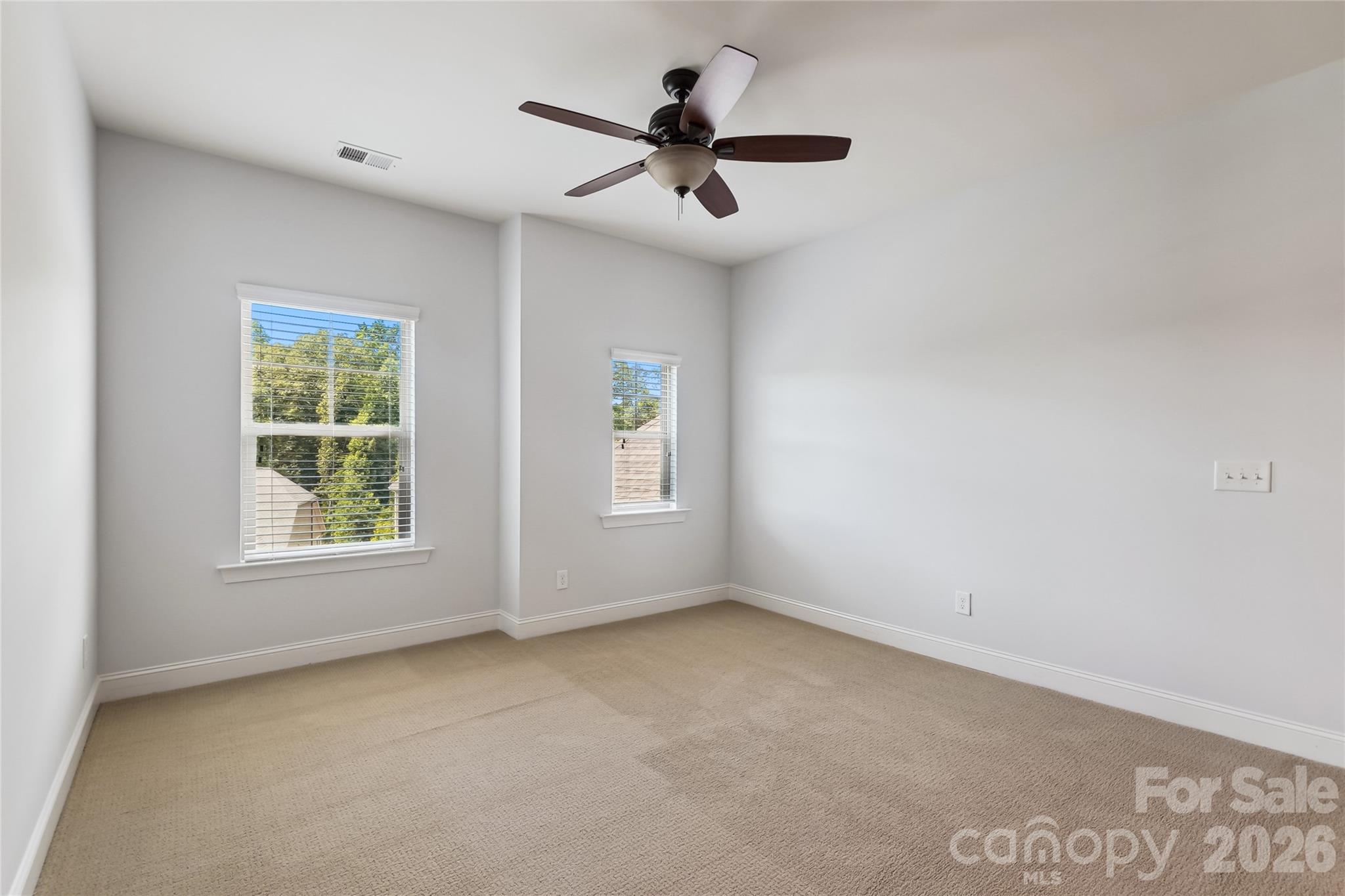 657 Chase Court Fort Mill, SC 29708 - Photo 19 of 39 an empty room with windows and ceiling fan
