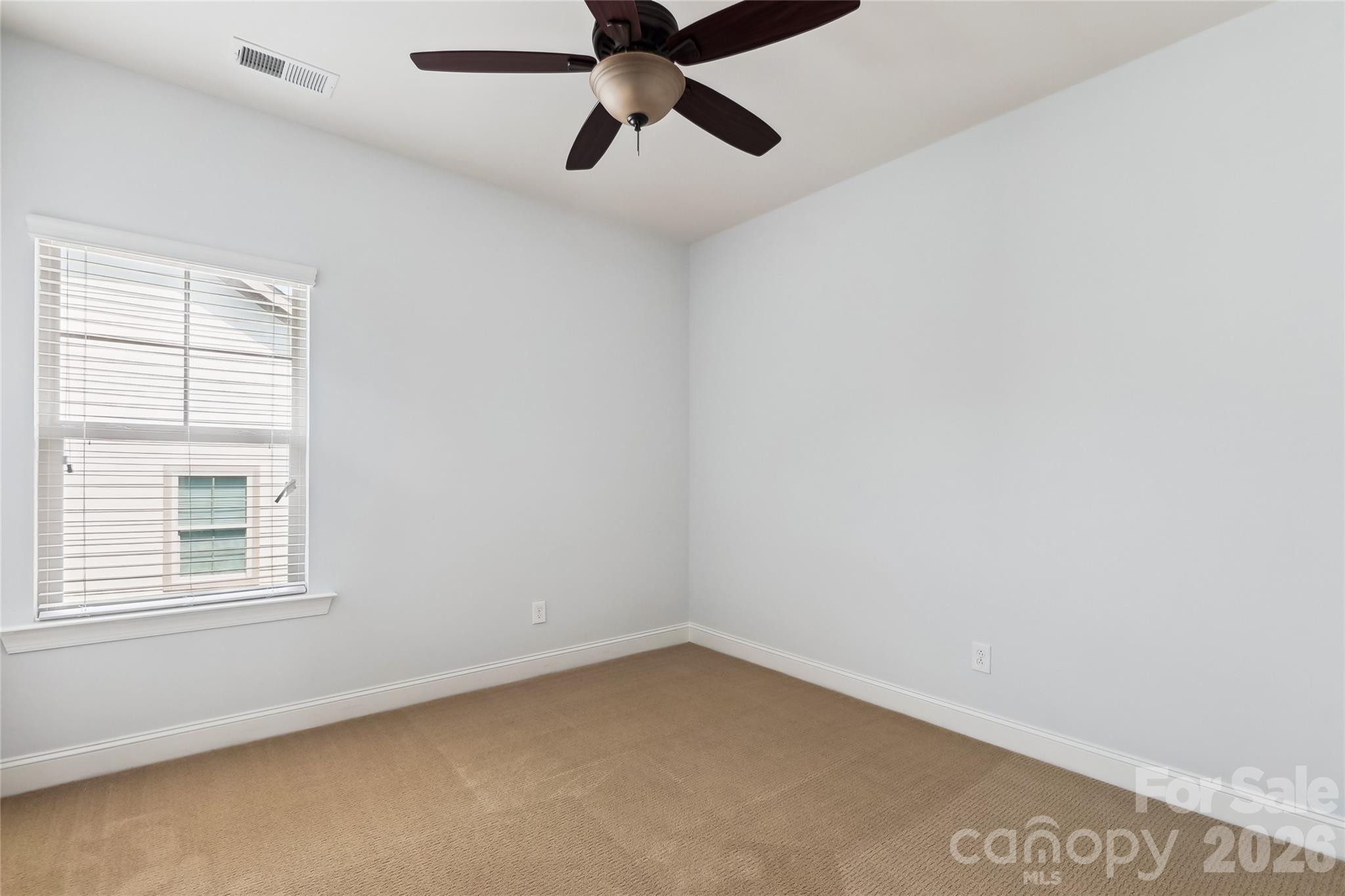 657 Chase Court Fort Mill, SC 29708 - Photo 26 of 39 an empty room with a window and a fan