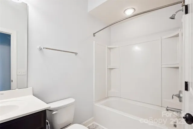 a white toilet sitting next to a bath tub