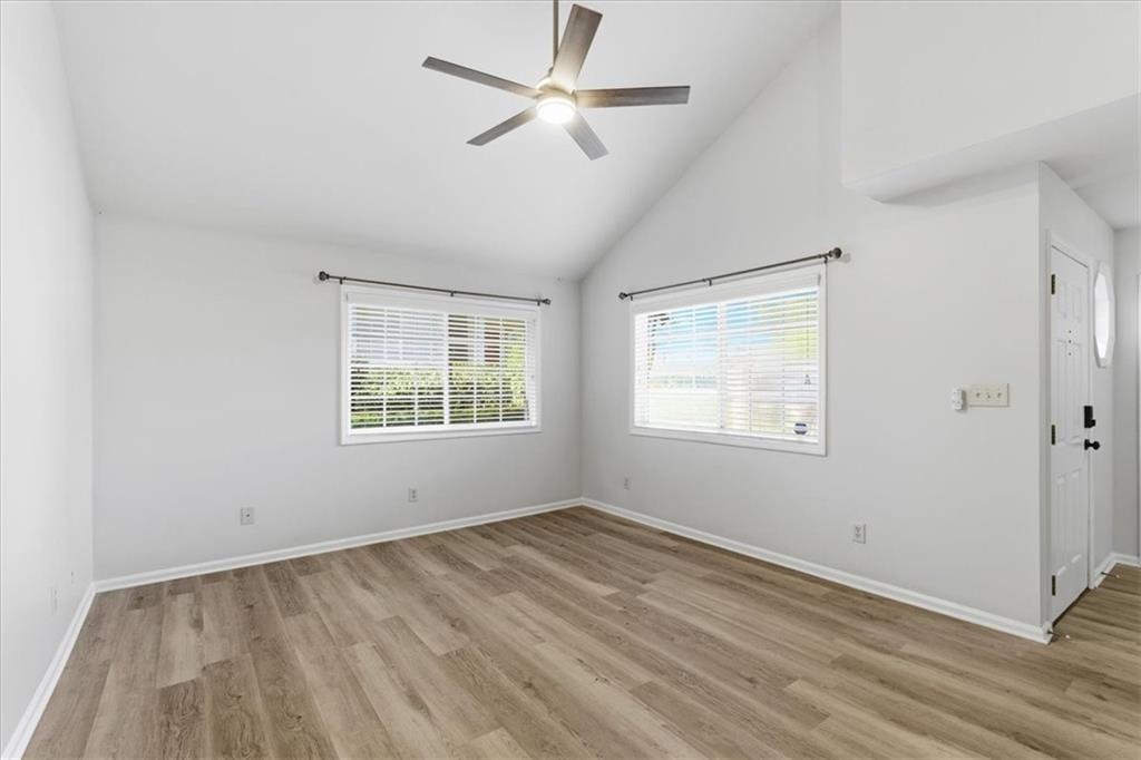 1468 Briarwood Road Northeast, Unit 303 Brookhaven, GA 30319 - Photo 11 of 32 a view of empty room with wooden floor and fan