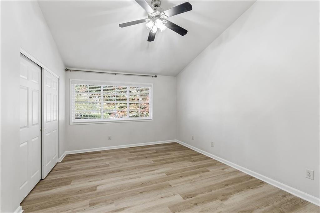 1468 Briarwood Road Northeast, Unit 303 Brookhaven, GA 30319 - Photo 14 of 32 a view of an empty room with wooden floor and a window