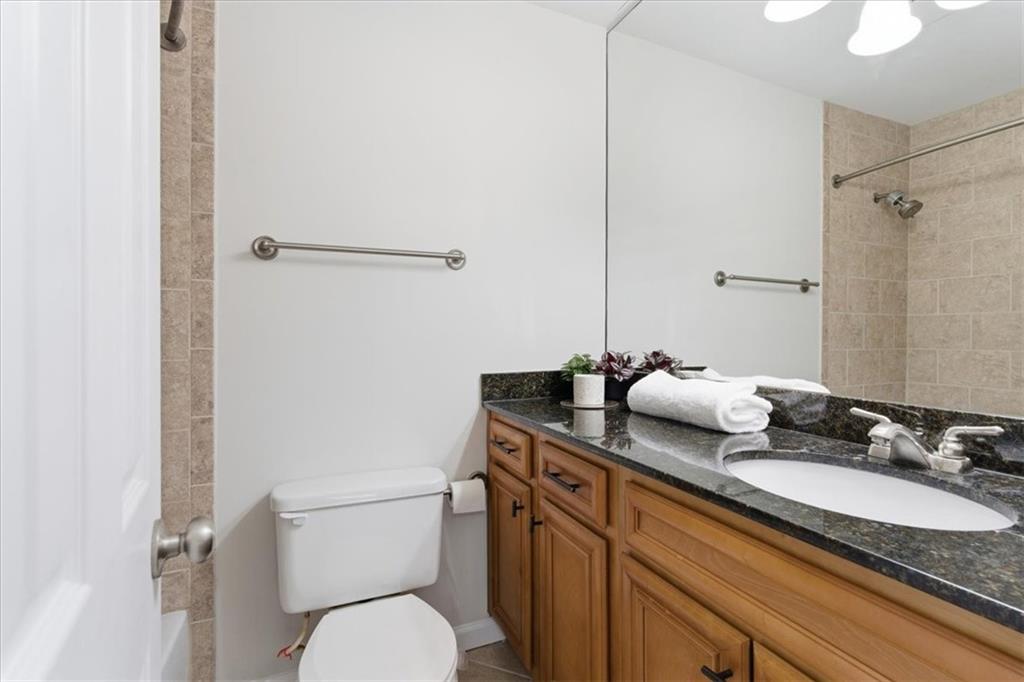 1468 Briarwood Road Northeast, Unit 303 Brookhaven, GA 30319 - Photo 17 of 32 a bathroom with a granite countertop sink mirror and toilet