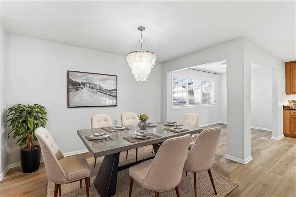 1468 Briarwood Road Northeast, Unit 303 Brookhaven, GA 30319 - Photo 3 of 32 a view of a dining room with furniture window and wooden floor
