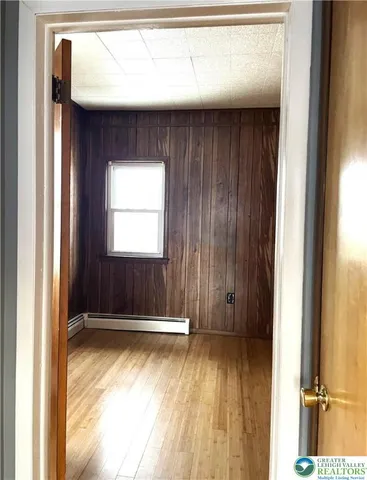 a view of door with wooden floor