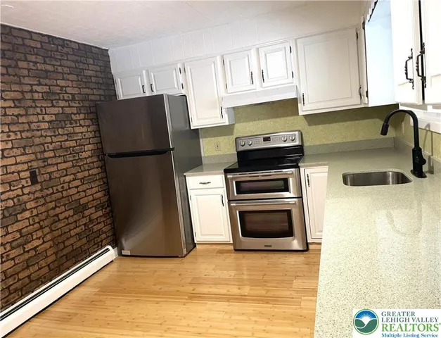 a kitchen with granite countertop a refrigerator and a stove