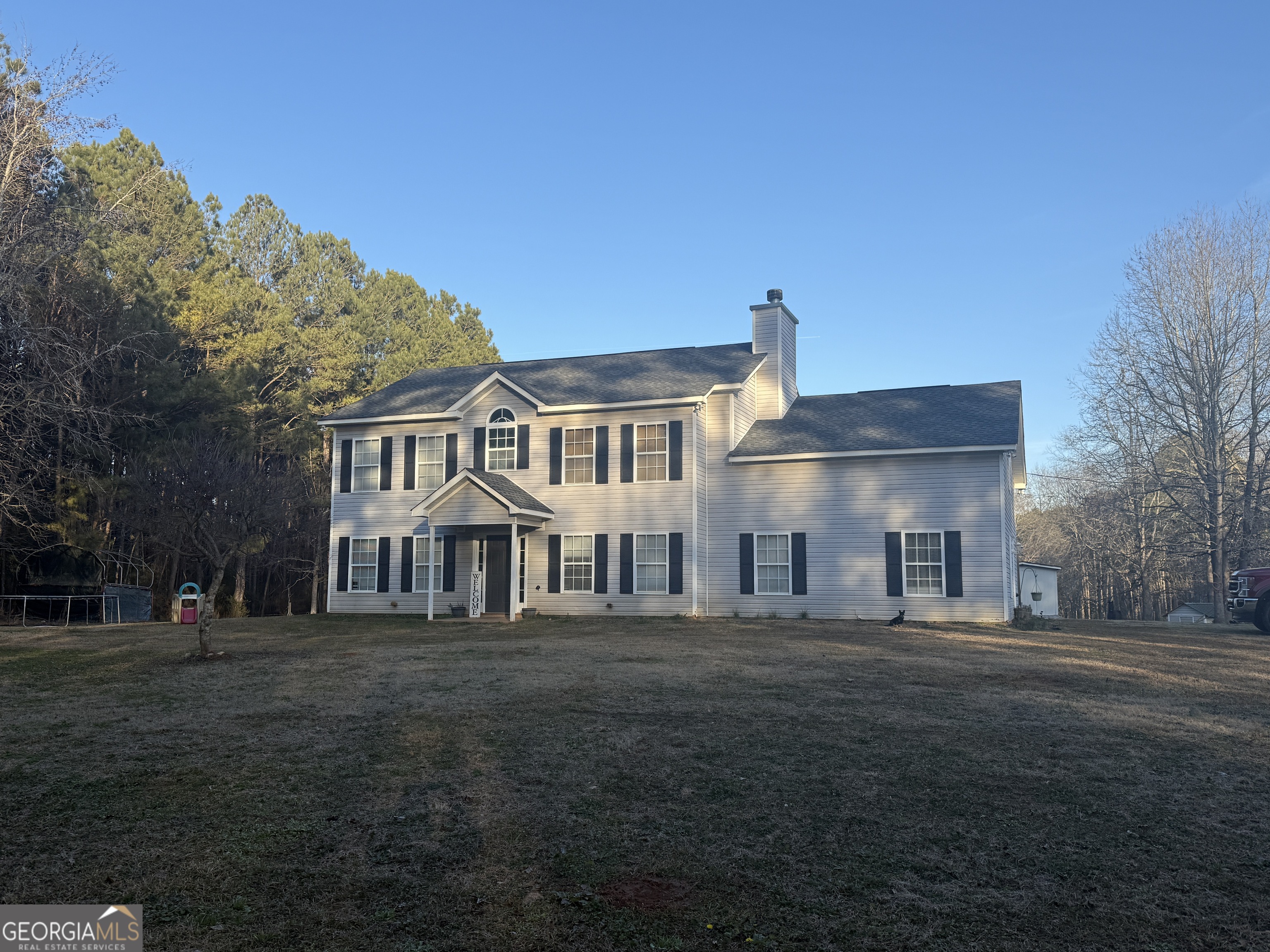 582 W Road Williamson, GA 30292 - Photo 1 of 1 a front view of a building with a garden