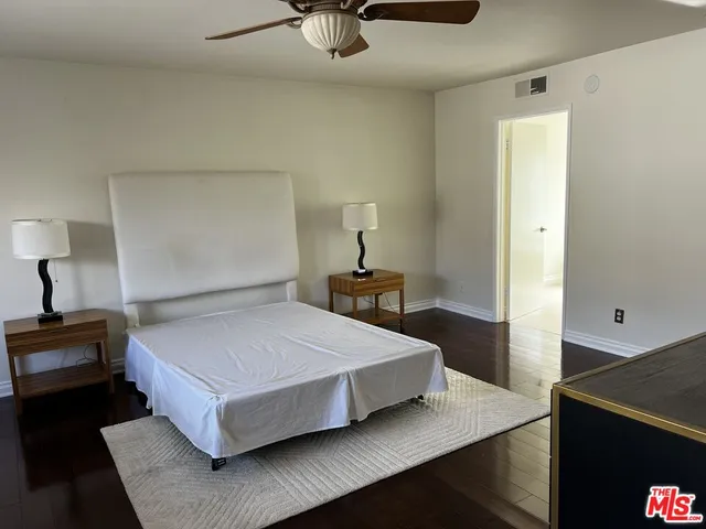 a bedroom with a bed and a lamp on table