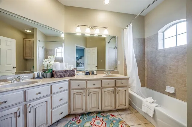 a spacious bathroom with a sink a large mirror and a bathtub