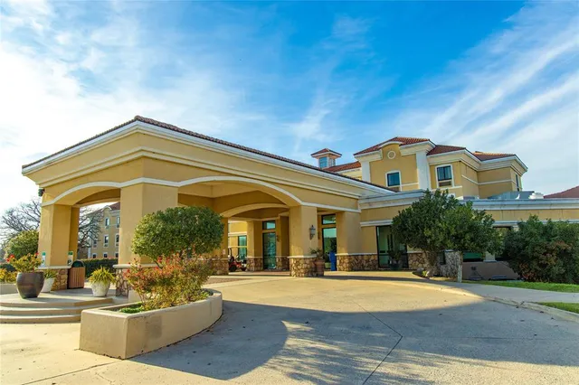a view of a building with couches and table