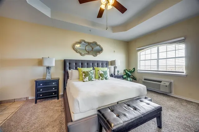 a bedroom with a bed dresser and a window