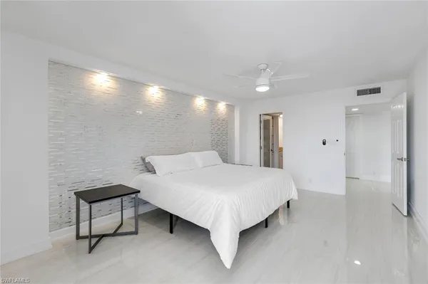 a spacious bedroom with a bed and a table