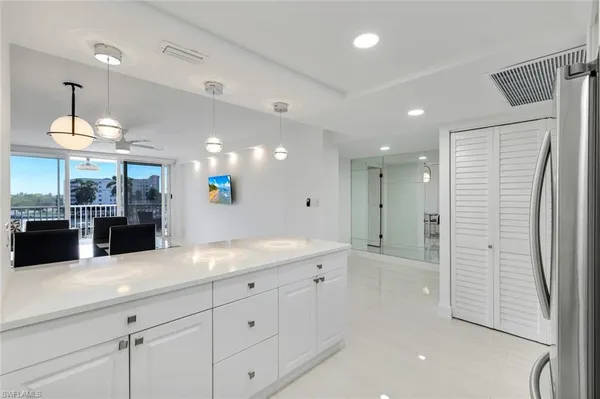 a spacious bathroom with a granite countertop sink mirror and shower
