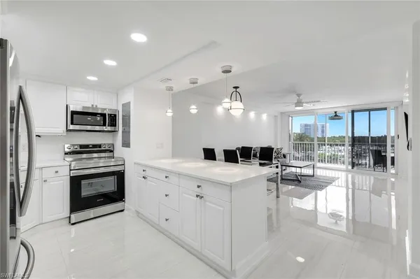 a kitchen with a sink stainless steel appliances and cabinets