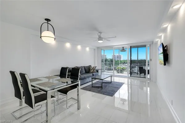 a living room with furniture a floor and a chandelier