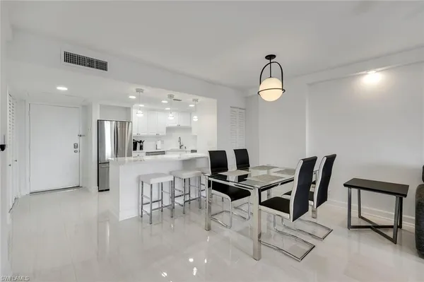 a dining room with furniture and a chandelier