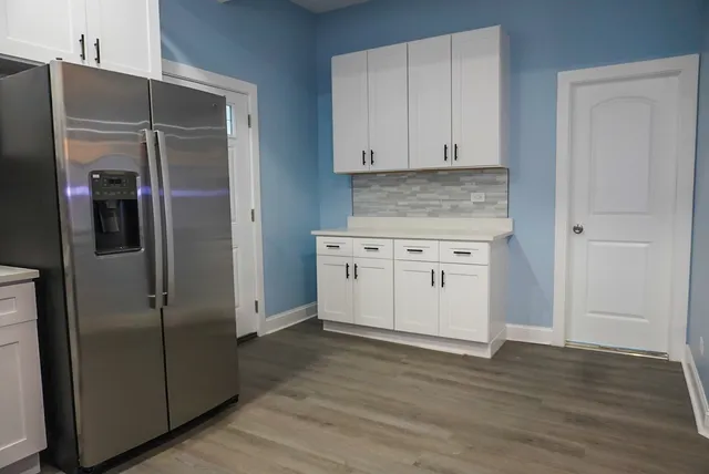 a kitchen with a refrigerator and a sink